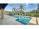Bright screened-in pool with clear blue water, surrounded by lush greenery and open sky at 12520 Natureview Cir, Bradenton, FL 34212