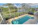 The screened-in pool area offers privacy, with a pool, chairs, and view of the community pond at 12520 Natureview Cir, Bradenton, FL 34212