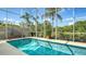 An inviting screened-in pool is complemented by a lounge swing to complete a perfect spot for relaxation and entertainment at 12520 Natureview Cir, Bradenton, FL 34212
