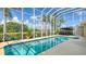 Sparkling pool with a screened enclosure overlooking a scenic lake at 12520 Natureview Cir, Bradenton, FL 34212