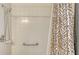 Clean shower with white tiles, a safety grab bar, and a decorative shower curtain at 12520 Natureview Cir, Bradenton, FL 34212