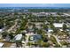An aerial view of a home with a modern design and a private pool in a lush, green neighborhood near the coast at 1323 Loma Linda Ct, Sarasota, FL 34239