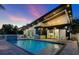 Inviting backyard features a sparkling pool, lounge chairs, and an outdoor kitchen, perfect for entertaining at 1323 Loma Linda Ct, Sarasota, FL 34239