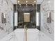 Stunning bathroom featuring a soaking tub, marble accents, and gold fixtures in an elegant and modern design at 1323 Loma Linda Ct, Sarasota, FL 34239