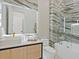 Bathroom with marble tile, modern vanity, soaking tub, and glass-enclosed shower at 1323 Loma Linda Ct, Sarasota, FL 34239
