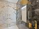 Luxurious bathroom features a dual shower with elegant marble and gold fixtures, creating a spa-like experience at 1323 Loma Linda Ct, Sarasota, FL 34239