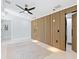 Modern bedroom with stylish wood paneling and a ceiling fan offers a serene and inviting atmosphere at 1323 Loma Linda Ct, Sarasota, FL 34239