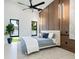 Bedroom featuring large windows, a ceiling fan, and a modern design with wood accents at 1323 Loma Linda Ct, Sarasota, FL 34239