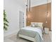 Bedroom with accent wall, neutral tones, decorative lighting, and a comfortable bed at 1323 Loma Linda Ct, Sarasota, FL 34239