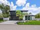 Contemporary two-story home boasts a sleek design, modern finishes, and lush landscaping at 1323 Loma Linda Ct, Sarasota, FL 34239