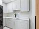 Well-organized laundry room features sleek cabinets and a modern washer/dryer for convenient chores at 1323 Loma Linda Ct, Sarasota, FL 34239