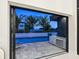 Outdoor kitchen and a view of the private pool from behind sliding glass doors at 1323 Loma Linda Ct, Sarasota, FL 34239