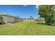 Spacious backyard with a well-kept lawn and secure wooden fence, ideal for outdoor activities and relaxation at 1334 De Prie Rd, Englewood, FL 34223