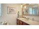 Bathroom featuring neutral paint, a white vanity with marble top, and framed artwork at 1334 De Prie Rd, Englewood, FL 34223