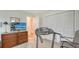 Bedroom featuring a large dresser, television, and workout area with a treadmill at 1334 De Prie Rd, Englewood, FL 34223