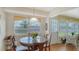 Bright dining area with a glass table, wooden chairs, and scenic outdoor views at 1334 De Prie Rd, Englewood, FL 34223