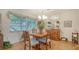 Bright dining area featuring wood floors, a charming light fixture and lots of natural light at 1334 De Prie Rd, Englewood, FL 34223