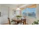 Charming dining room featuring a glass-top table, wooden chairs, and bright window at 1334 De Prie Rd, Englewood, FL 34223