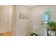 Bright entryway featuring tile flooring, white door, and sidelight providing ample natural light at 1334 De Prie Rd, Englewood, FL 34223