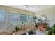 Cozy Florida room with wicker furniture, plenty of natural light, and serene outdoor views at 1334 De Prie Rd, Englewood, FL 34223