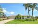 Charming single-story home featuring a lush green lawn, tropical landscaping, and an attached two-car garage at 1334 De Prie Rd, Englewood, FL 34223
