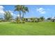 Single-story home with well-manicured lawn, tropical landscaping, and charming curb appeal at 1334 De Prie Rd, Englewood, FL 34223