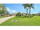 Charming home with a well-manicured front yard, lush landscaping, and a welcoming driveway leading to the garage at 1334 De Prie Rd, Englewood, FL 34223