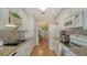 Well-lit kitchen with white cabinets, granite countertops, and stainless steel appliances at 1334 De Prie Rd, Englewood, FL 34223