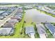 Panoramic aerial view of a residential area with stunning lake views and meticulously landscaped properties at 13549 Old Creek Ct, Parrish, FL 34219