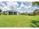 Spacious backyard with a screened lanai, offering an inviting outdoor living space and ample green area at 13549 Old Creek Ct, Parrish, FL 34219