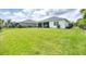 Expansive backyard featuring lush green grass, manicured landscaping, and a well-maintained lawn at 13549 Old Creek Ct, Parrish, FL 34219