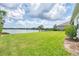 Spacious backyard overlooking a tranquil lake, offering a serene and picturesque outdoor space at 13549 Old Creek Ct, Parrish, FL 34219