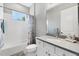 This bathroom features a shower-tub combo, single sink vanity and bright natural light at 13549 Old Creek Ct, Parrish, FL 34219