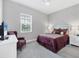 Tranquil bedroom featuring a plush queen-sized bed, soft carpet, and a peaceful view from the window at 13549 Old Creek Ct, Parrish, FL 34219