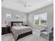 Bedroom featuring neutral carpet, recessed lighting, large windows, and a comfortable chair at 13549 Old Creek Ct, Parrish, FL 34219