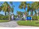 Leisure Cove's community pool entrance features a paved walkway, lush landscaping and clear signage at 13549 Old Creek Ct, Parrish, FL 34219
