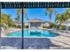 Stunning community pool with ample seating, lush landscaping, and a shaded cabana for residents' enjoyment at 13549 Old Creek Ct, Parrish, FL 34219
