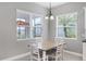 Bright dining area with white table set near windows offering serene views at 13549 Old Creek Ct, Parrish, FL 34219