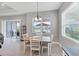 Dining area featuring sliding glass doors leading to a lanai with a grill at 13549 Old Creek Ct, Parrish, FL 34219