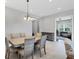 Dining room features a neutral color palette, tile flooring and modern furnishings at 13549 Old Creek Ct, Parrish, FL 34219