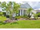 Beautifully landscaped yard of this single-Gathering home highlights the manicured lawn and vibrant foliage at 13549 Old Creek Ct, Parrish, FL 34219