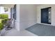 Charming front porch with stylish blue door, blue shutters, comfortable seating and a welcoming entrance at 13549 Old Creek Ct, Parrish, FL 34219