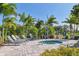 Community hot tub surrounded by lounge chairs and lush tropical landscaping at 13549 Old Creek Ct, Parrish, FL 34219