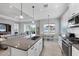Kitchen featuring stainless steel appliances, and a view of the dining area, living room and lanai at 13549 Old Creek Ct, Parrish, FL 34219