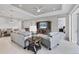 The living area is complete with tray ceilings, ceiling fan, and a seamless flow to other living spaces at 13549 Old Creek Ct, Parrish, FL 34219