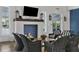 Cozy lounge featuring a fireplace, comfortable seating, and ample natural light perfect for relaxation at 13549 Old Creek Ct, Parrish, FL 34219