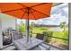 Enjoy al fresco dining on the covered patio with views of the lake and landscaped backyard at 13549 Old Creek Ct, Parrish, FL 34219