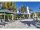 Relaxing pool area with shaded lounge seating and lush landscaping near the clubhouse at 13549 Old Creek Ct, Parrish, FL 34219