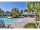 Relaxing community pool area with sunshades, lounge chairs, and lush landscaping at 13549 Old Creek Ct, Parrish, FL 34219
