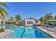 Inviting pool area with lounge chairs and a clubhouse view, perfect for relaxation at 13549 Old Creek Ct, Parrish, FL 34219